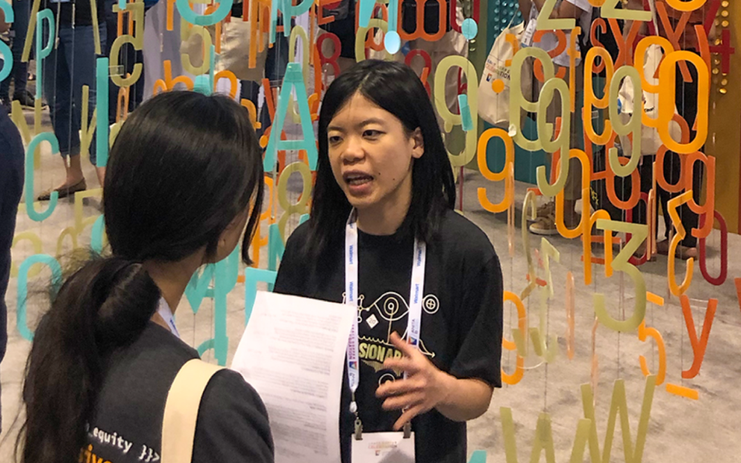 Picture of two women talking animatedly together at a campus event