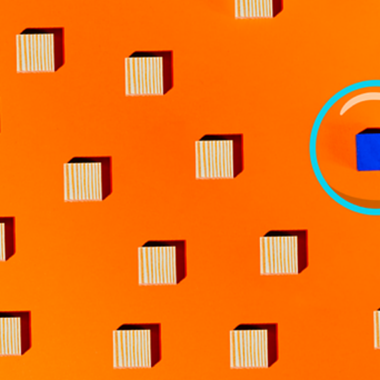 Rows of striped wooden cubes on an orange background, with one cube turned blue and highlighted inside a cyan magnifying glass.