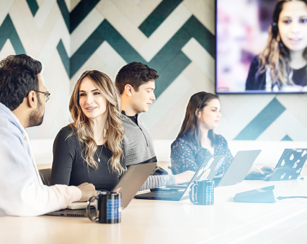 Diverse group of Two Sigma employees in a conference room.