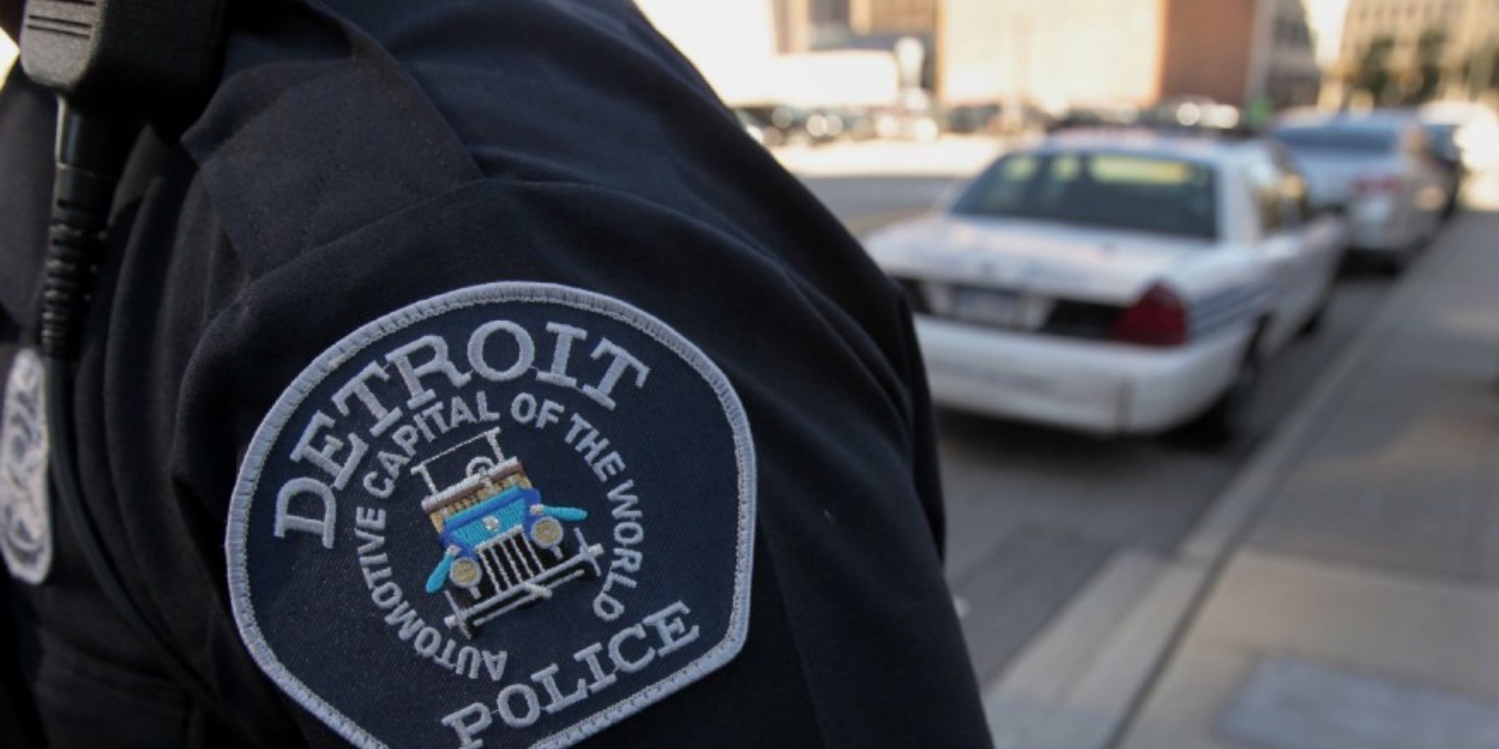 Close up of a Detroit police uniform that reads 'Automotive capital of the world'.