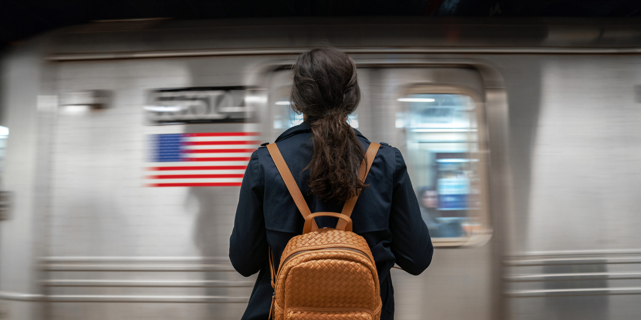 Woman waits on a New York City subway platform.