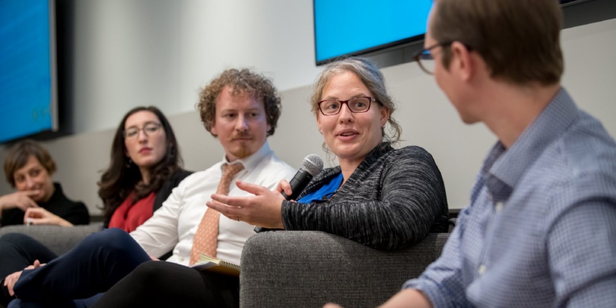 Panelists chat amongst each other at the Data for Good conference.