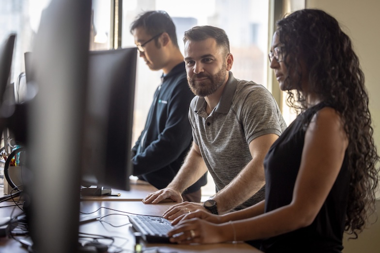 Employees working on screens together