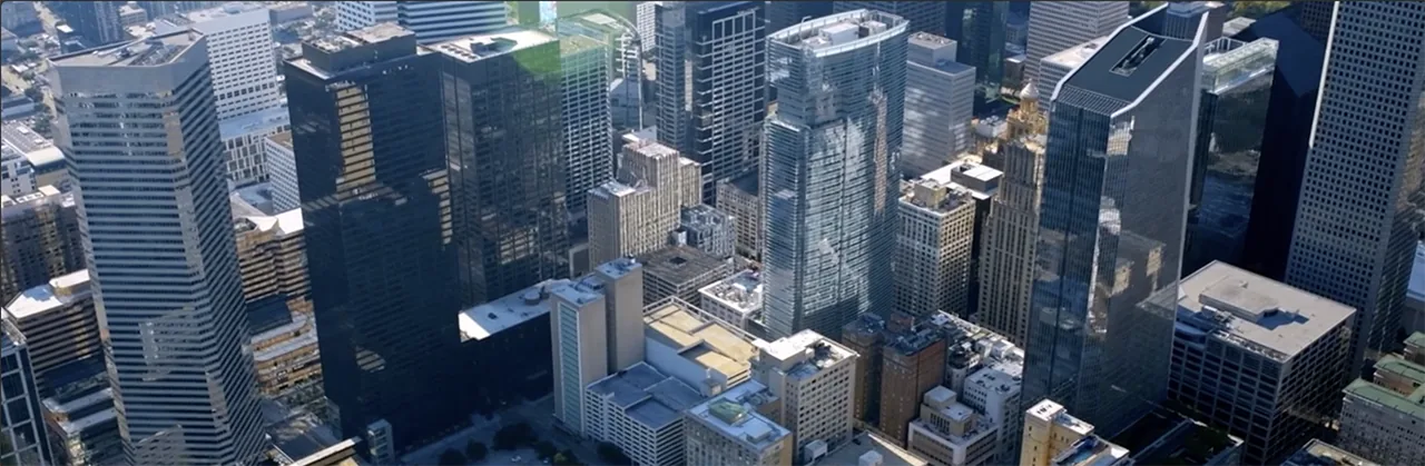 Aerial view of downtown Houston with clusters of high-rise office buildings.