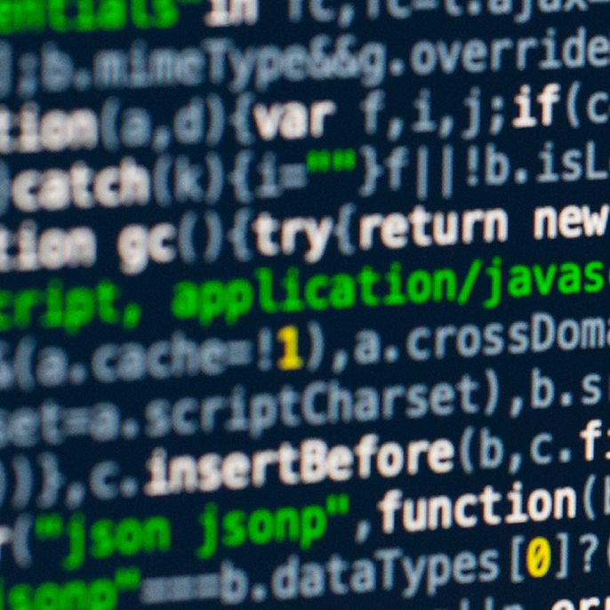 Close-up of a computer screen showing colorful JavaScript code against a dark background.