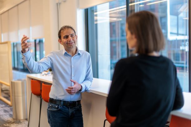 leader speaking to colleague in the office