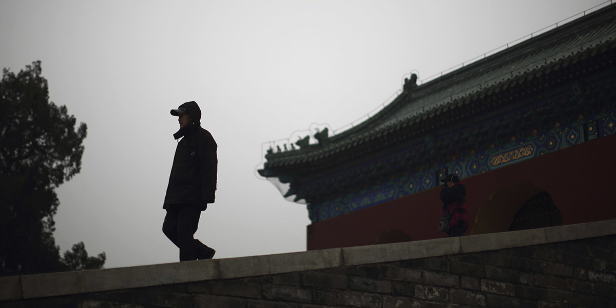 Man in front of a Chinese architecture building