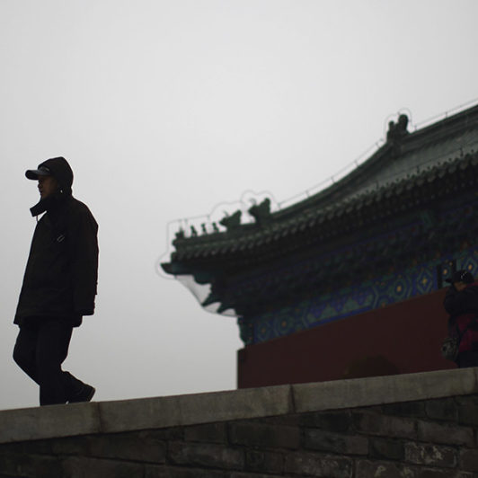 Man in front of a Chinese architecture building