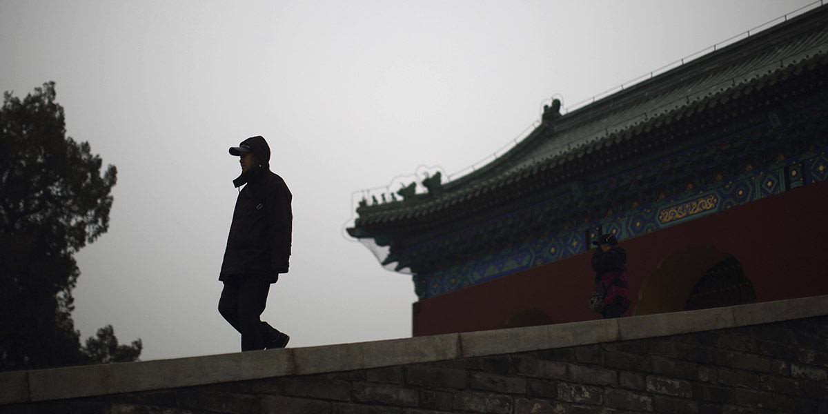 Man in front of a Chinese architecture building