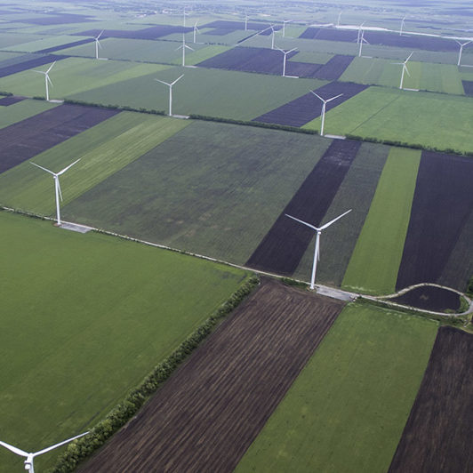 A sky view of a windmill farm