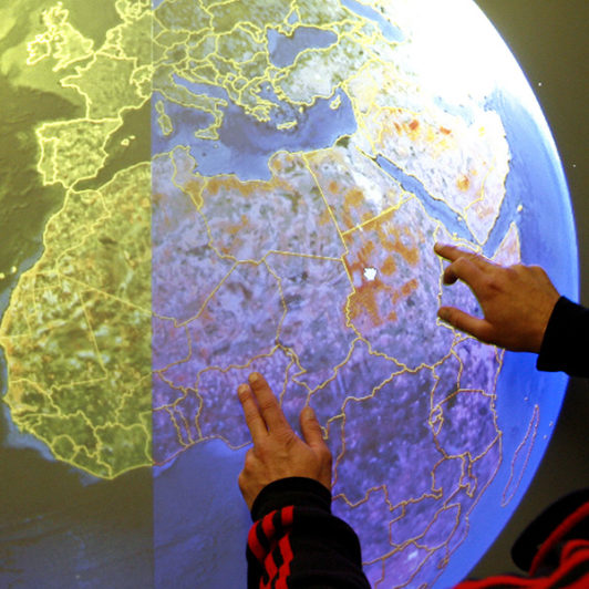 A man touching a digital model of the earth
