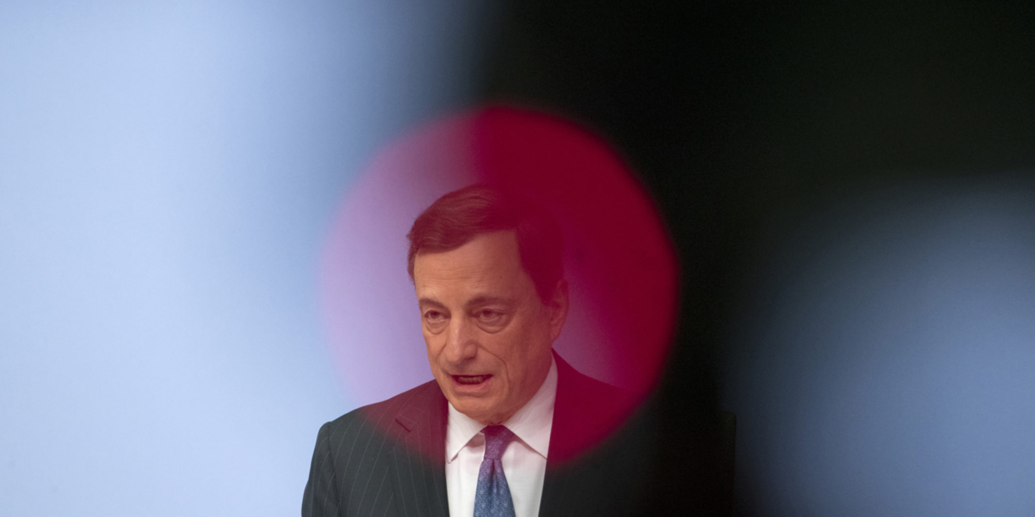 Picture of Mario Draghi giving a speech with a red circle over his him
