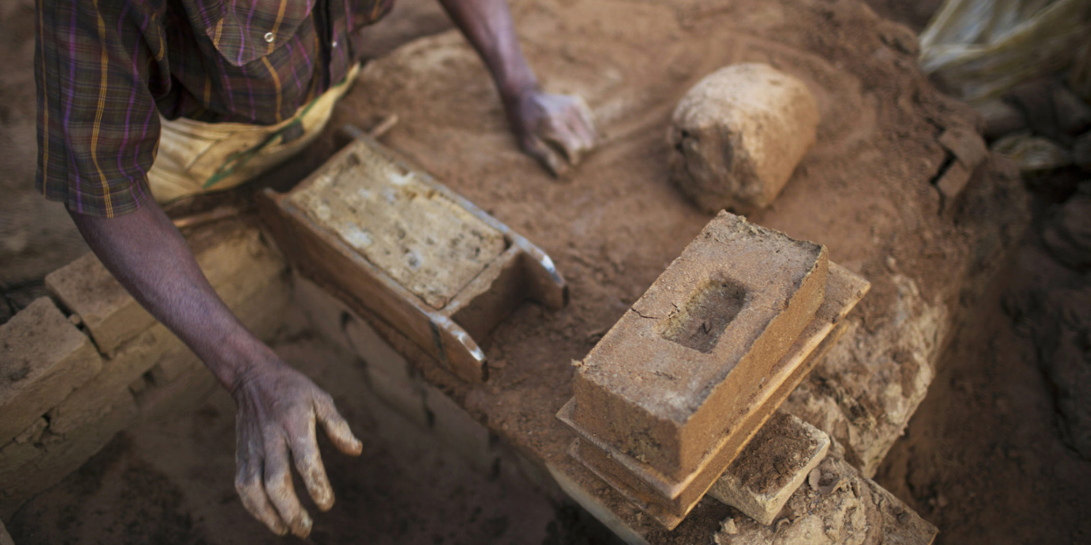 A man making Bricks by hand