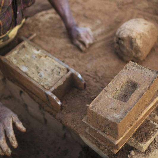 A man making Bricks by hand